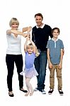 Mother Helping Her Little Ballerina Twirl. Family Beside Stock Photo