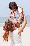 Mother Holding Son On Beach Stock Photo