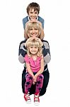 Mother Posing With Her Adorable Son And Daughter Stock Photo