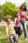 Mother Running With Children Stock Photo
