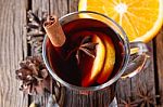 Mulled Wine And Spices On Weathered Wooden Table Stock Photo