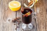 Mulled Wine And Spices On Weathered Wooden Table Stock Photo