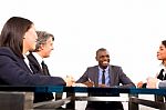 Multi Ethnic Team During Meeting Stock Photo