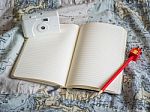 Notebook With Red Pencil And White Film Camera On Map Pattern Stock Photo