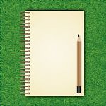 Notebook With White Page On Green Grass Background Stock Photo