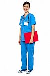 Nurse Wearing Blue Uniform And Holding Red Clipboard Stock Photo