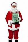 Old Man Dressed As Santa Showing A Large Green Calculator Stock Photo