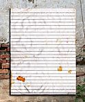 Old Paper On Grunge Brick Wall Stock Photo