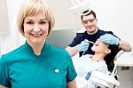 Orthodontist, Patient And Assistant In Clinic Stock Photo