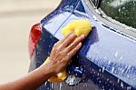 Outdoor Blue Car Wash With Yellow Sponge Stock Photo