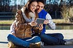 Outdoor Portrait Of Young Couple With Digital Tablet Stock Photo