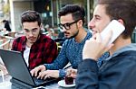 Outdoor Portrait Of Young Entrepreneurs Working At Coffee Bar Stock Photo