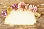 Paper Sheets And Flowers On Wooden Table Stock Photo