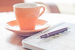 Pen And Spiral Notebook With Coffee Cup Stock Photo