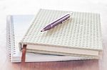 Pen And Two Of Notebooks On Wooden Table Stock Photo