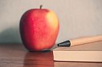 Pencil With Apple On Desk Stock Photo