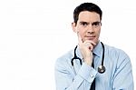 Pensive Physician Looking At Camera Stock Photo