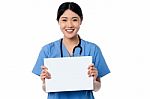 Physician Holding Blank White Ad Board Stock Photo