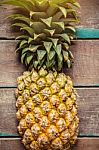 Pineapple On The Wooden Stock Photo