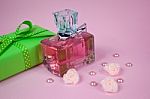 Pink Aromatic Perfume With Green Vintage Gift And Pearls And Roses On Pink Background Stock Photo