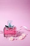 Pink Aromatic Perfume With Pink Pearls And Pink Textile Roses On Pink Background Stock Photo