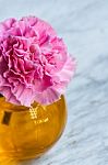 Pink Artificial Flower In Brown Round Bottle Stock Photo