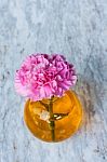 Pink Artificial Flower In Brown Round Bottle Stock Photo