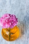 Pink Artificial Flower In Brown Round Bottle Stock Photo