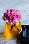 Pink Artificial Flower In Brown Round Bottle Stock Photo