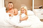 Playful Couple In Bed Stock Photo