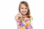 Portrait Of A Cheerful Kid Pointing Towards You Stock Photo