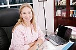 Portrait Of A Pediatrician Working At Table Stock Photo