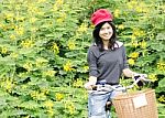 Portrait Of An Happy Smiling Girl Riding A Bicycle In The Park Stock Photo