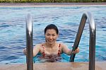 Portrait Of Asian Woman Getting Out Of A Swimming Pool Stock Photo