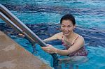 Portrait Of Asian Woman Getting Out Of A Swimming Pool Stock Photo