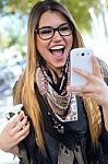 Portrait Of Beautiful Girl Drinking Coffee And Using Her Mobile Stock Photo