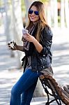 Portrait Of Beautiful Girl Drinking Coffee And Using Her Mobile Stock Photo