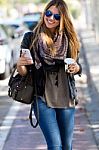 Portrait Of Beautiful Girl Drinking Coffee And Using Her Mobile Stock Photo