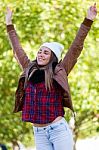 Portrait Of Beautiful Girl Standing In Autumn Field With Arms Ra Stock Photo