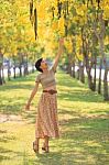 Portrait Of Beautiful Young Asian Woman Relaxing In Flowers Park Stock Photo