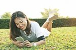 Portrait Of Beautiful Young Woman Lying And Playing And Watching Stock Photo