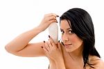 Portrait Of Female Holding Lotion Bottle Against White Background Stock Photo