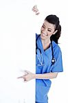 Portrait Of Female Nurse Standing Behind The White Board Stock Photo