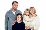 Portrait Of Friendly Family Of Four In The Studio Stock Photo