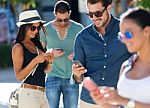 Portrait Of Group Of Friends Having Fun With Smartphones Stock Photo