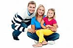 Portrait Of Happy Couple Smiling With Cute Daughter Stock Photo