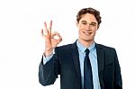 Portrait Of Smiling Businessman Showing Ok Sign Stock Photo