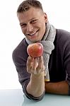 Portrait Of Smiling Man Holding Apple Stock Photo