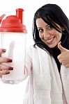 Portrait Of Smiling Woman With Water Bottle Showing Thumb Up Stock Photo