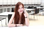 Portrait Of Thai Adult Beautiful Girl Using Her Smart Phone And Smile Stock Photo